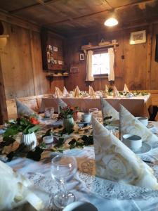 ein Esszimmer mit einem langen Tisch mit Blumen darauf in der Unterkunft Landgasthof Steiner in Matrei in Osttirol