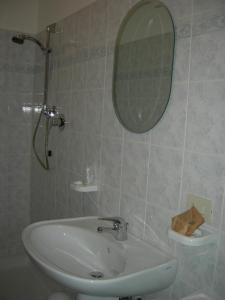 łazienka z umywalką i lustrem w obiekcie Casa Vacanze Fortini w mieście Piano Delle Pieve