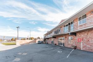 a parking lot in front of a building at Alexandra Heights Motel in Alexandra