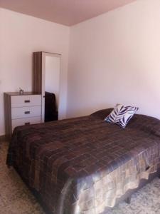 a bedroom with a bed and a dresser at Tákate in Costa Azul