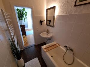 a bathroom with a bath tub and a sink at Ferienwohnung Kirsten in Markranstädt +55 photos