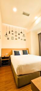 Postel nebo postele na pokoji v ubytování Qlio Hotel