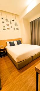 Postel nebo postele na pokoji v ubytování Qlio Hotel