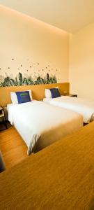 Postel nebo postele na pokoji v ubytování Qlio Hotel