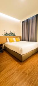 Postel nebo postele na pokoji v ubytování Qlio Hotel