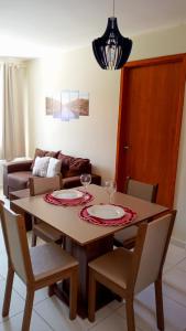 a dining room table with two wine glasses on it at Apartamento Beira Rio no Condomínio Brisas do Lago in Paulo Afonso