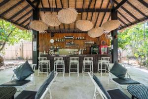 a living room filled with furniture and a patio area at The Sevenseas Resort Koh Kradan in Koh Kradan