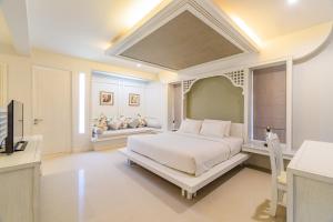 a white bedroom with a bed and a television at Villa Pimmada in Ao Nang Beach +31 photos