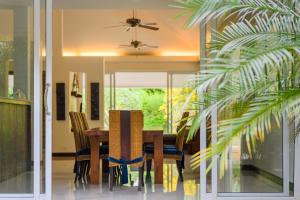 a dining room with a table and chairs at Villa Pimmada in Ao Nang Beach