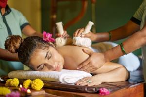 a woman getting a massage in a spa tub at Sarth Ayurveda Retreat and Wellness Centre in Sawantwadi