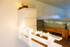 a small room with a bed and lights in it at TinyHaus auf Annettes Kinderbauernhof in Bad Lauterberg