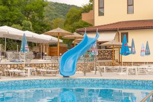 a blue slide in a pool at a resort at Eco Hotel Momata in Kolarovo