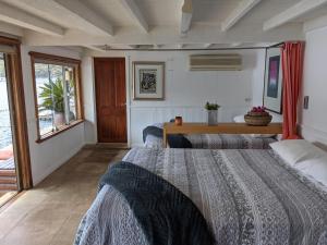 a bedroom with two beds and a table in it at Cottage Point - Paradise Found in Berowra +23 photos