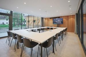 a large conference room with a long table and chairs at Triangel Boutique Hotel in Kranjska Gora
