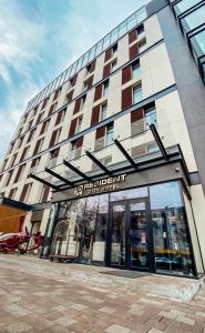 a building with a sign on the front of it at Resident City Hotel in Almaty