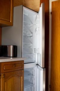 an empty refrigerator with its door open in a kitchen at Haus Pia - Monteur Haus in Bubesheim