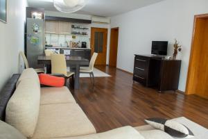 a living room with a couch and a table at Central Apartment Mountain View in Karlovo