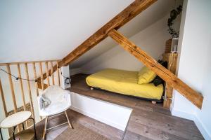 a bed in the attic of a house at Le Boheme - Rent4night Grenoble in Grenoble