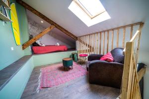 a attic room with a couch and two beds at Le Pop'Art - Rent4night Grenoble in Grenoble