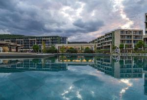a large pool of water in front of some buildings at HVD Reina del Mar - Premium Spa Service & Free Parking in Obzor