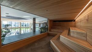 an empty sauna with wooden walls and a large window at HVD Reina del Mar - Premium Spa Service & Free Parking in Obzor
