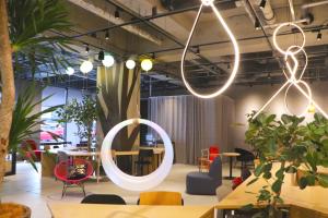 a room with a round mirror and some chairs at Hotel The M's Kyoto in Kyoto