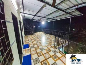 a walkway with a tile floor at night at Rane's Ambadnya Niwas in Nagaon