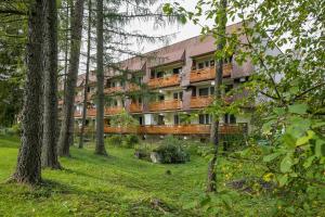 a building in the middle of a forest with trees at Rent like home - Żeromskiego 10 in Zakopane