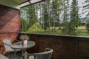 a patio with a table and chairs and a large window at Rent like home - Żeromskiego 10 in Zakopane
