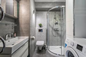 a bathroom with a shower and a toilet and a sink at Rent like home - Żeromskiego 10 in Zakopane