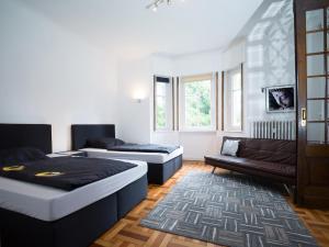 a living room with two beds and a couch at Villa Mondial in Wadern