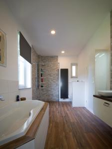 a large bathroom with a tub and a sink at Villa Mondial in Wadern +44 photos