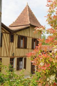 a house with a roof with trees in front of it at Domaine de la Source in Sainte-Christie-dʼArmagnac