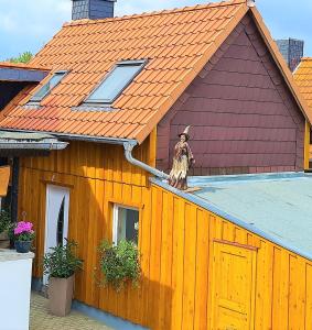 a statue of a man standing on the roof of a house at Ferienhaus Heider II in Altenrode
