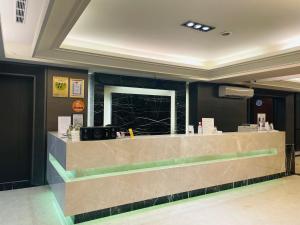 a lobby with a counter in a building at Felicity Business Hotel in Taichung
