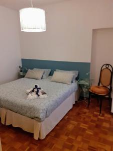 a bedroom with a bed and a chair at Il Balcone Sul Corso in Ancona