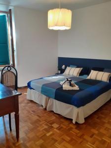 a bedroom with a large blue bed in a room at Il Balcone Sul Corso in Ancona