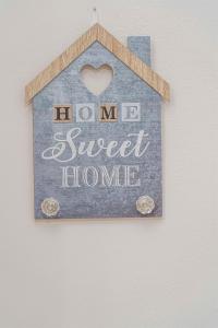 a sign that says im sweet home on a wall at Tzortzi's Family Apartments in Kaloi Limenes