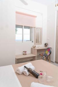 a white room with a table with towels on it at Tzortzi's Family Apartments in Kaloi Limenes