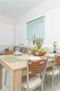 a dining room with a table with a bowl of fruit at Tzortzi's Family Apartments in Kaloi Limenes