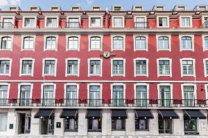 a large red building with windows and balconies at The 7 Hotel, Suites, Studios & Apartments in Lisbon