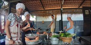 a group of people in a kitchen preparing food at Phuket Nonnita Boutique Resort - SHA Plus in Phuket Town