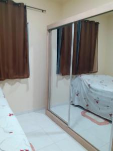 a mirror in a room with a bed and a window at Casa com Ar e piscina no centro in Prado +9 photos