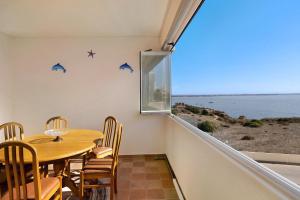 a dining room with a table and a view of the ocean at Apartamento Vista Mar in Lagos