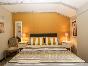 a bedroom with a large bed and two lamps at Pear Tree Cottage in Mark