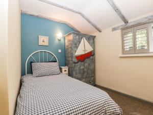 a bedroom with a bed in a room at Pear Tree Cottage in Mark