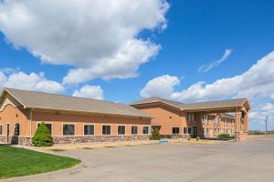 a large brick building with a parking lot at Quality Inn York in York