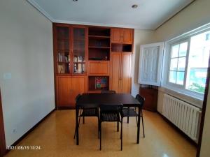 a dining room with a black table and chairs at Casa Lolita / Camino de Santiago / Porriño in Porriño