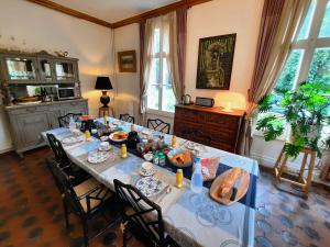 a dining room with a table with food on it at Manoir des Tuileries du Buisson in Verneuil d'Avre et d'Iton