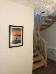 a picture hanging on a wall next to a staircase at Coille Darach B&B in Strontian